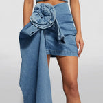 High-waist blue denim mini skirt with 3D flower design and asymmetric drape – women’s streetwear fashion