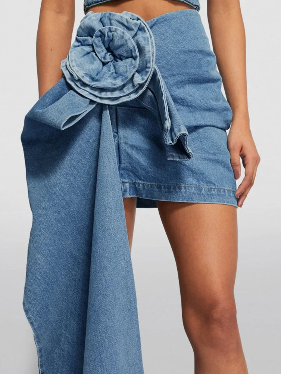 High-waist blue denim mini skirt with 3D flower design and asymmetric drape – women’s streetwear fashion