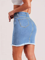 Light blue women’s denim mini skirt with raw hem, button closure, and front pockets – slim fit stretchy summer jeans skirt