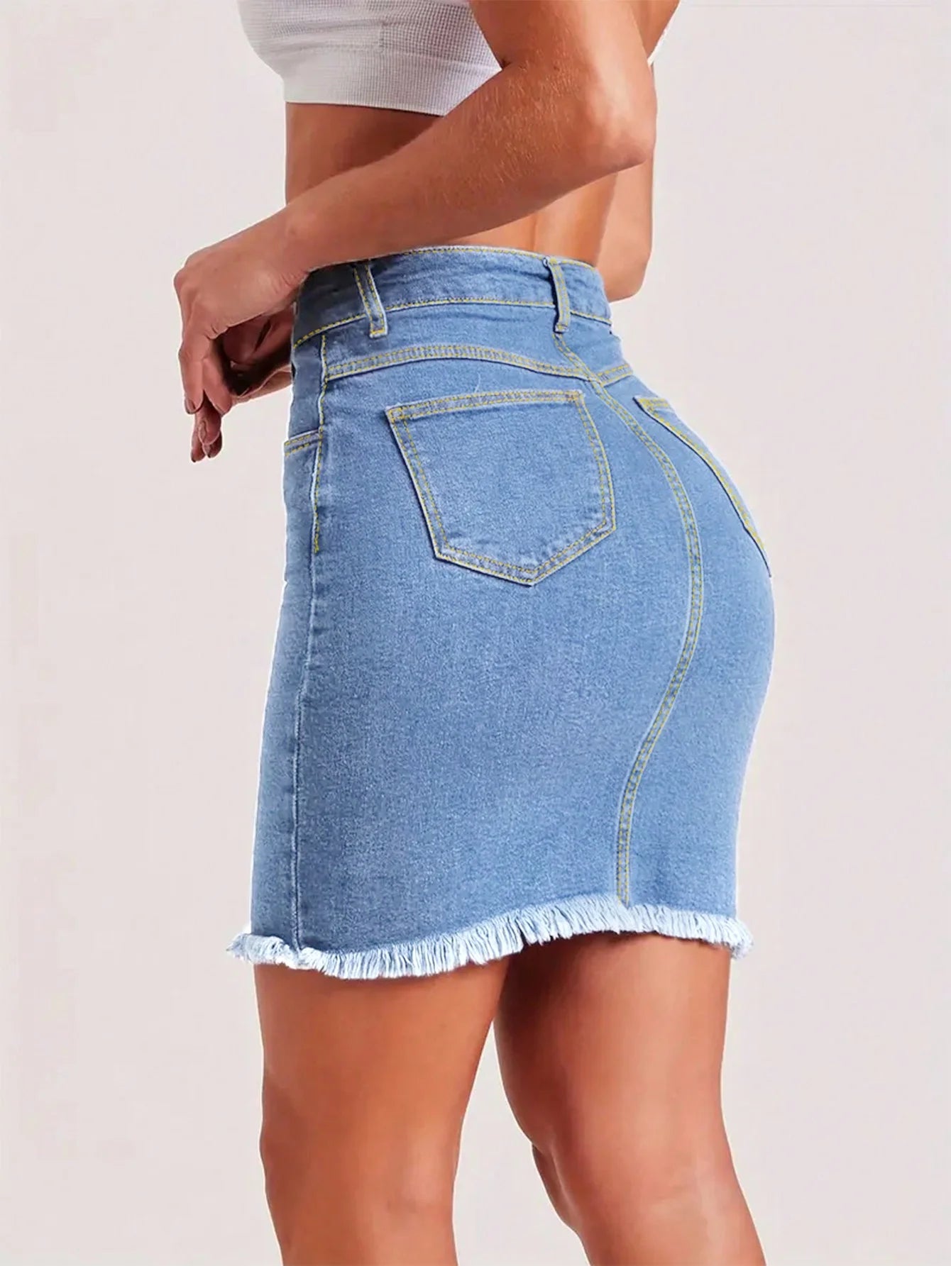 Light blue women’s denim mini skirt with raw hem, button closure, and front pockets – slim fit stretchy summer jeans skirt