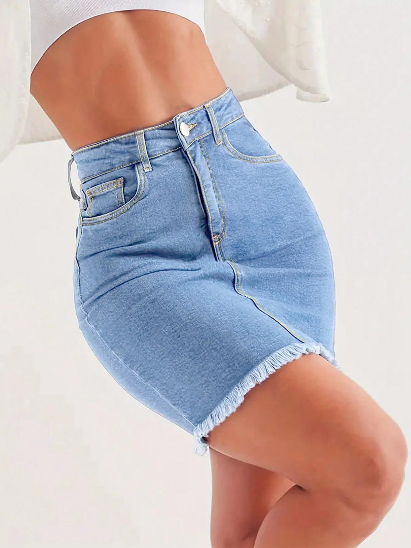 Light blue women’s denim mini skirt with raw hem, button closure, and front pockets – slim fit stretchy summer jeans skirt